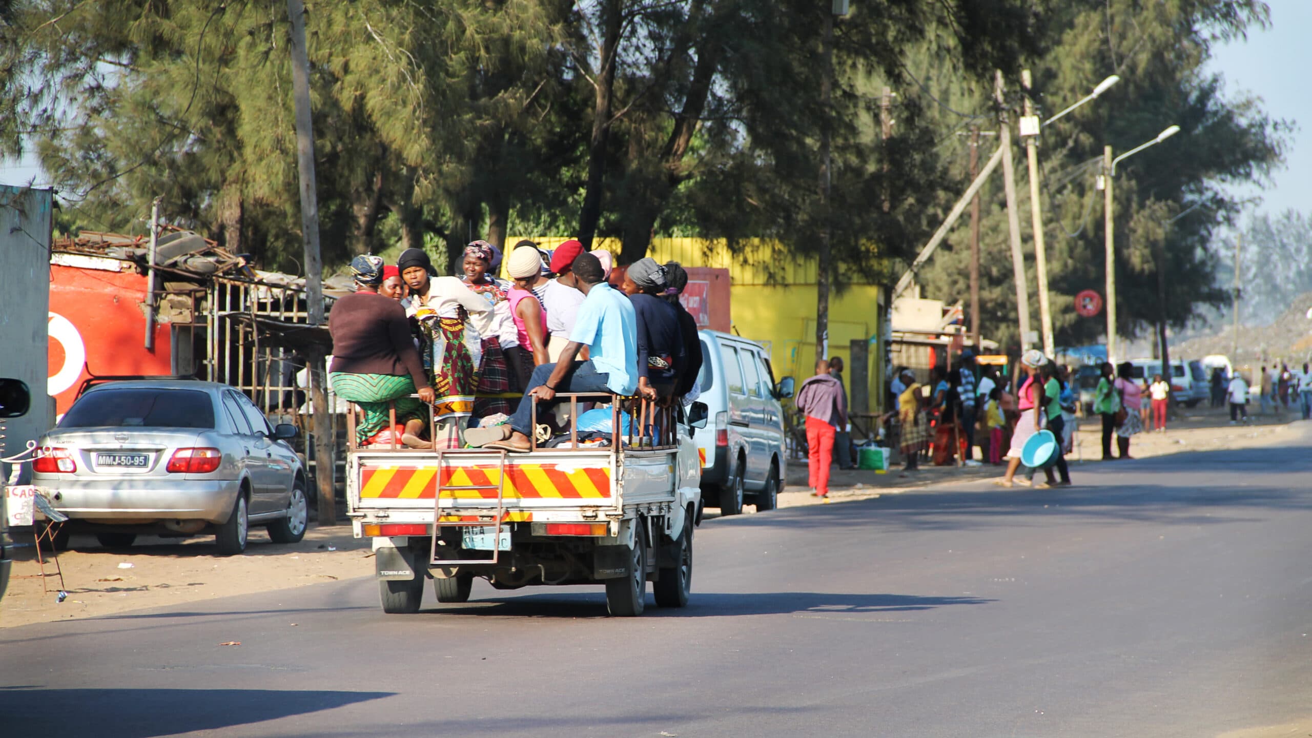 Photo: Diakonia A truck driving on a road, with a group of people on it.