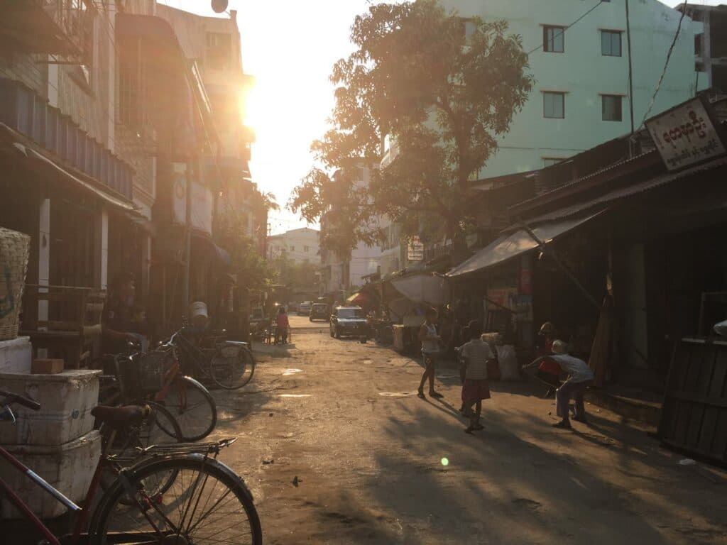 A street scene with houses and children playing in the street. A street scene with houses and children playing in the street.