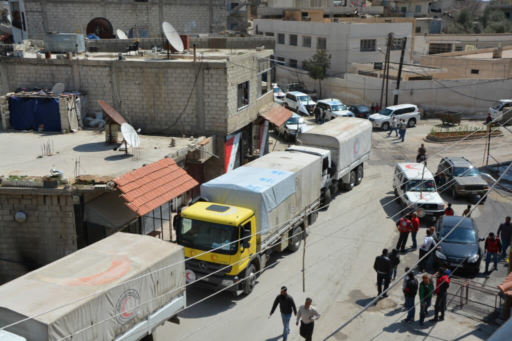 A convoy of trucks in a Syrian town. A convoy of trucks in a Syrian town.