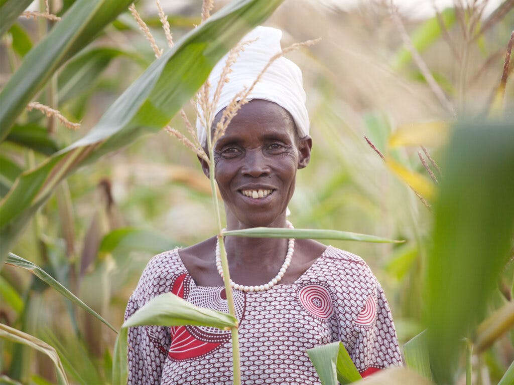 Kvinna står mitt i sin odling