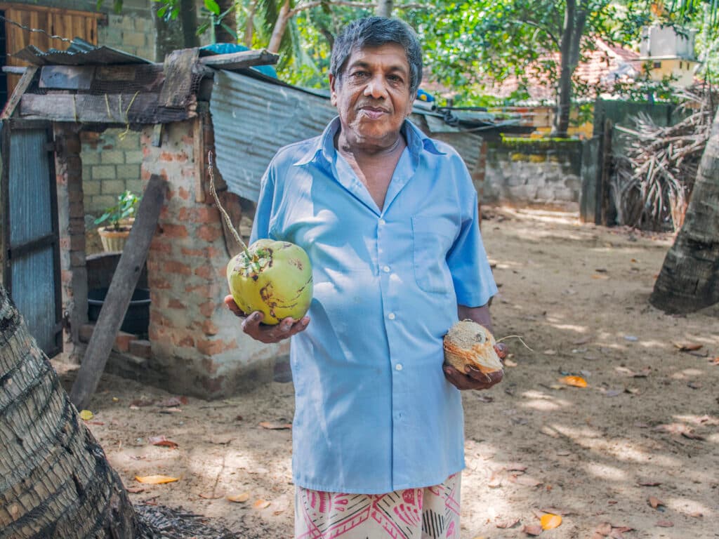 A man carrying two big fruits.