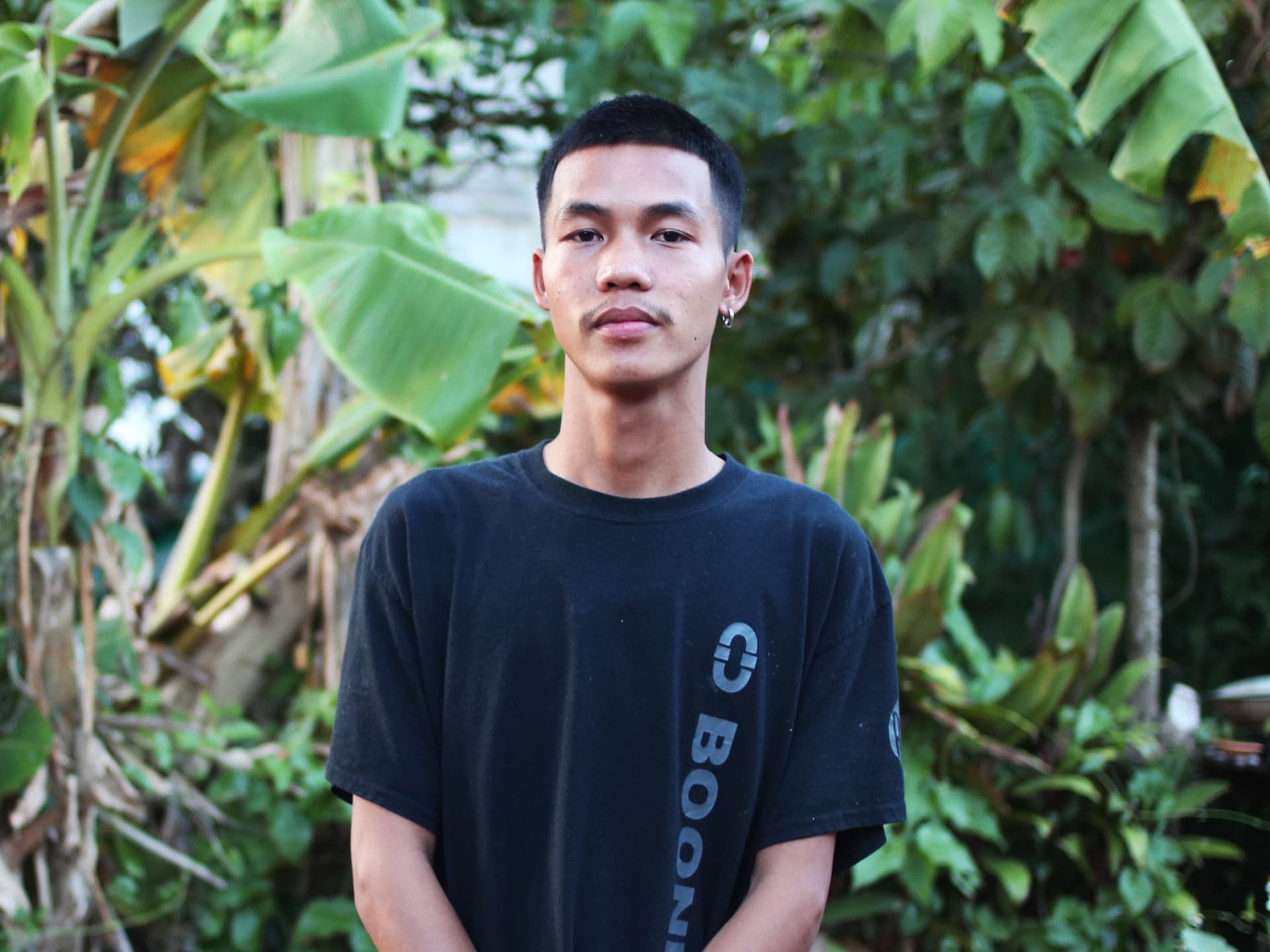 Photo: Josefin Hagström A young Thai man standing with trees behind him.